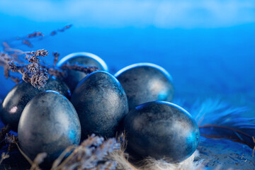 Easter blue eggs and lavender flowers, blue bright background copy space