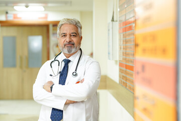 Wall Mural - Indian male senior doctor standing at hospital.