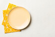 © sosiukin - Top view on colored background empty round yellow plate on tablecloth for food. Empty dish on napkin with space for your design