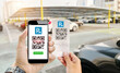 © panuwat - Qr code can parking payment concept.Hand holding mobile phone on blurred parking lot as background.