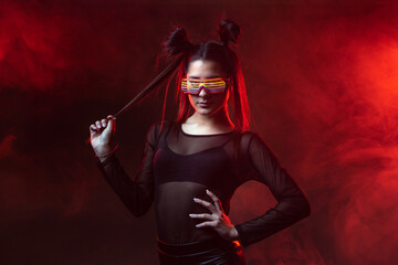 Portrait of beautiful cyber model woman posing wearing led glasses on head with neon light in a virtual tech environment