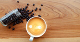 Fototapeta Mapy - White cup of espresso coffee and Roasted coffee beans on a wooden background