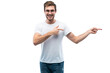 © opolja - Portrait of a joyful young man pointing fingers away at copy space on his palm isolated over transparent background