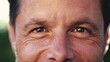 © Marco - Macro eyes of a happy man looking at camera. Close up of male 40s middle aged person smiling with wrinkles. Person eyesight vision closeup