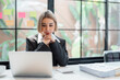 © Natee Meepian - Image of woman thinking and down working sitting at table at office