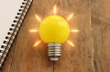 Wall Mural - Education concept image. Creative idea and innovation. light bulb metaphor over wooden background