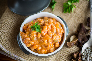 Wall Mural - beans stewed with vegetables and spices, in a bowl .