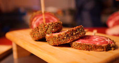 Wall Mural - Row beef roulade cuts with skewers on a wooden cutting board. Barbecue preps seasoned with pepper mix. Cooking conept.