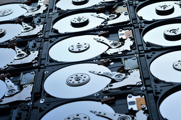 Wall Mural - Group of hard disk drives. Many Open Hard drives. Close-up of the inside of PC hard drives. Technology background. Selective focus