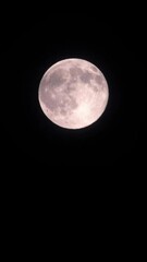 magical full moon at night. telephoto view of mysterious clouds flying against the bright full moon.