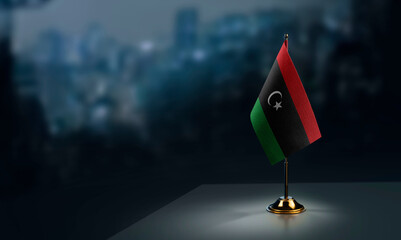 Poster - Small flags of the Libya on an abstract blurry background