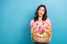 Photo Of Adorable Dreamy Woman Wear Pink Cardigan Looking Empty Space Rising Easter Sweets Basket Isolated Blue Color Background