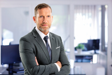 Wall Mural - Senior businessman wearing suit and tie while standing at the office