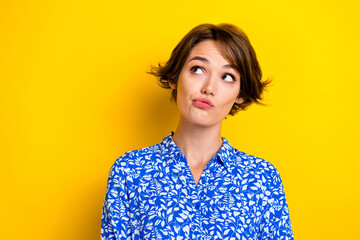 Poster - Photo of doubtful thoughtful young lady wear print shirt looking empty space isolated yellow color background