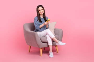 Wall Mural - Full body length photo of brown hair freelancer girl browsing smartphone writing her own blog about business life isolated on pink color background