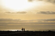© roberto - Silhouette at sunset of some walkers on the beach in Fuerteventura
