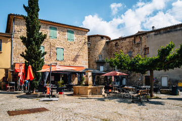 Wall Mural - Terrace of a restaurant in summer on the main square of Boulieu Les Annonay in the south of France (Ardeche)