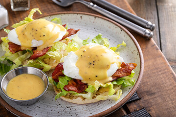 Wall Mural - Eggs Benedict with bacon and lettuce on english muffins