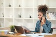 © Treerat - Smart African women working in beautiful office, working on Laptop, use the phone, talking on the cellphone.