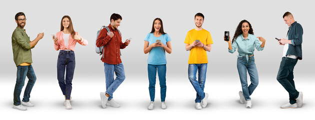 Smiling excited millennial different men and women in casual show smart phone with empty screen, chatting