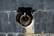 Large Metal Ring Recessed In A Black Stone Wall At Fort Pickens