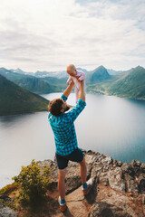 Wall Mural - Family vacations in Norway. Father traveling with infant baby hiking outdoor healthy lifestyle man with child in mountains Senja island aerial view