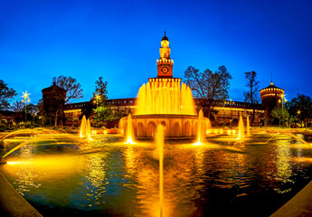 Wall Mural - Panorama of the illuminated fountain before facade of Sforza's Castle in Milan, Italy