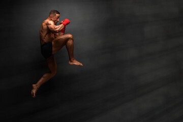 martial art fighter performing flying knee kick