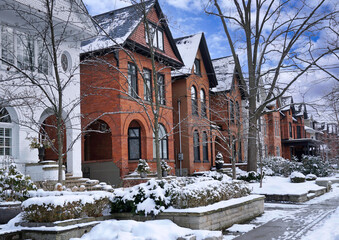 Wall Mural - Residential street with traditional brick houses with gables in winter