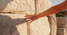 Young Woman Touch Hand Of Wall In Ruin Ancient Greek City, Close-up Shot