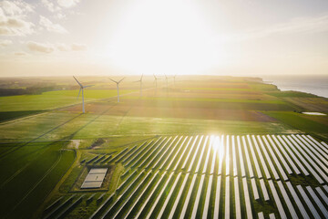 wind turbines and solar panels farm in a field. renewable green energy. sunny landscape, electric en
