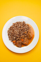 Poster - Boiled buckwheat with meat and sauce on white dish