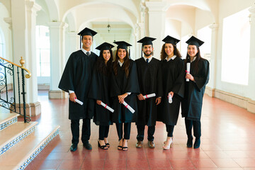 Portrait of graduates friends posing at university campus