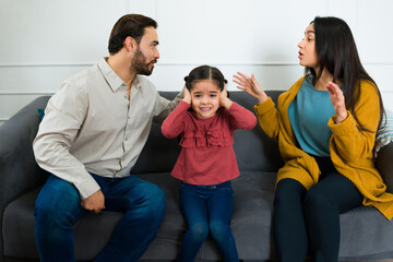 Annoyed young daughter in the middle of her parents fight