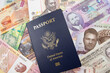 An American passport on a background of African currency