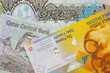 A yellow swiss franc paired with purple, green and blue Qatari money
