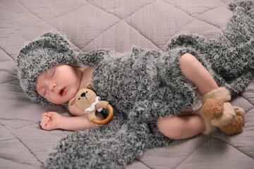 Canvas Print - Cute newborn baby sleeping with teething toy in bed