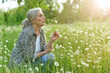 © aletia2011 - old woman in a field with dandelions in summer