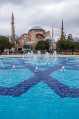 Wall Mural - Fountain with blue tiled floor near ancient mosque