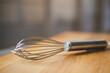 © Cavan Images - Close-up of wire whisk on wooden table