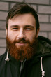 © Cavan Images - Emotional portrait of a handsome young man with red beard.