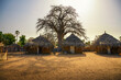 Leinwandbild Motiv Traditional village houses with a boabab tree in the background, Senegal, Africa