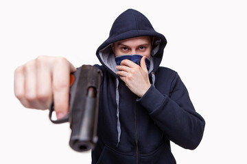 The male criminal in action of attacking with hand gun pointing gun to target in front. Isolated on gray background. The concept of crime for presentation slide.