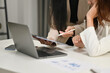 © Prathankarnpap - Business people looking at laptop brainstorming, collaborating on project development in corporate office