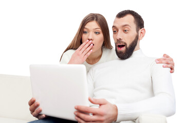 Portrait of a happy young couple learning how to use a laptop