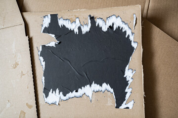 Wall Mural - Ripped black square paper on cardboard background