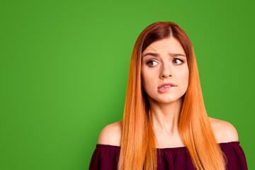 Sticker - Red straight-haired attractive cute nice scared young girl, biting lip. Copy space. Isolated over bright vivid yellow background