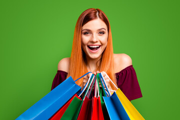 Sticker - Black friday Red-haired girl laughs holding multicolored vivid shopping bags isolated on yellow background