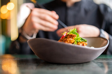 man hand eat chicken curry rice holding chopsticks