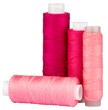 Spools with red and pink thread for sewing, craft supply, isolated cut out object on transparent or white background